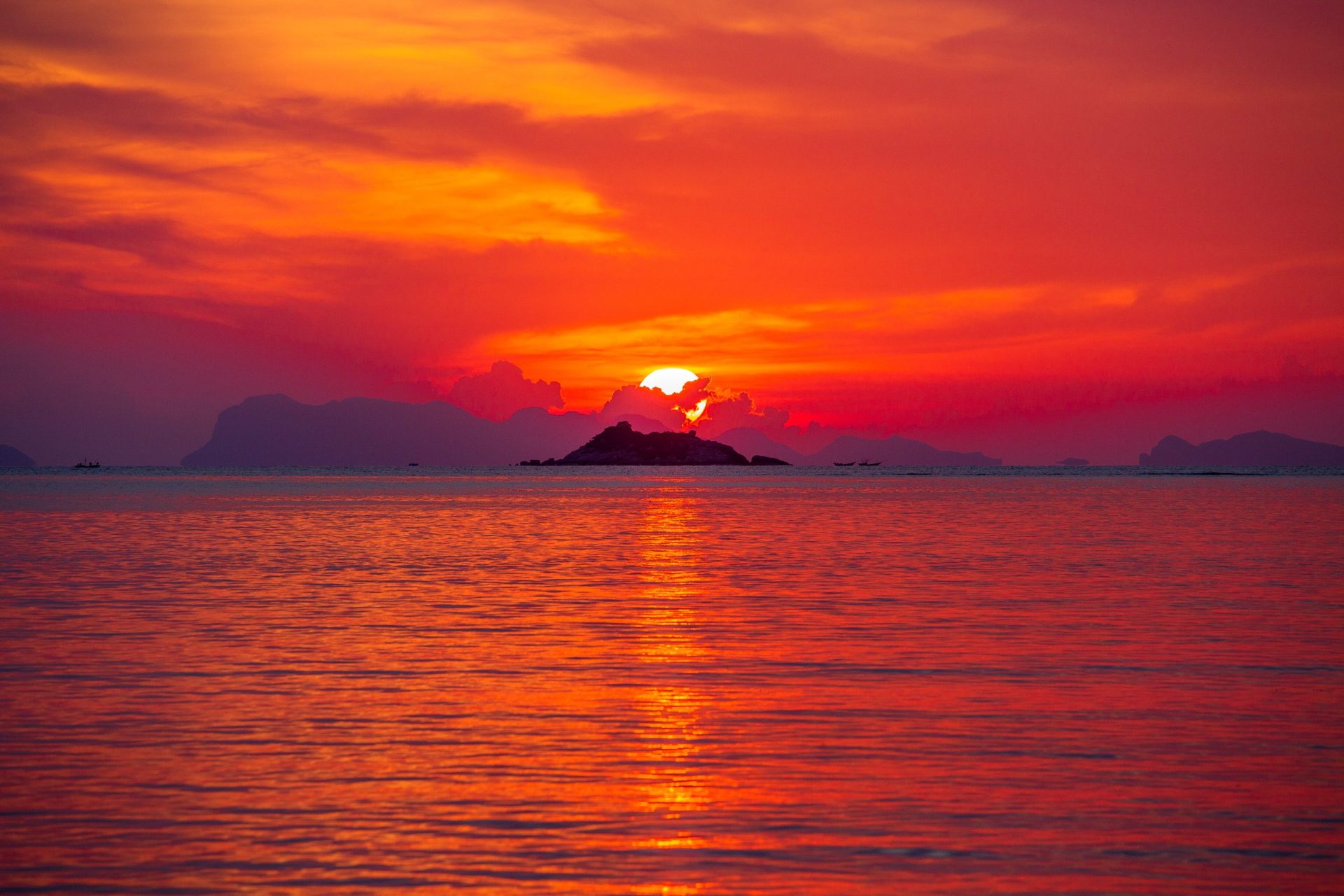 Beautiful colourful sunrise at the sea with dramatic clouds and sun shining
